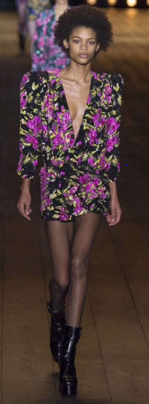 Creative director Anthony Vaccarello dirupts the moody aura with injections of floral motifs on similar silhouettes.